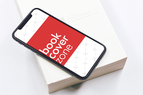 Closeup of iPhone X on Book with iOS App Screen