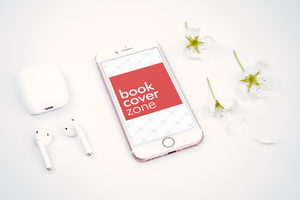 iPhone with AirPods and Flowers