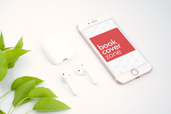 iPhone with AirPods Next to Leaves