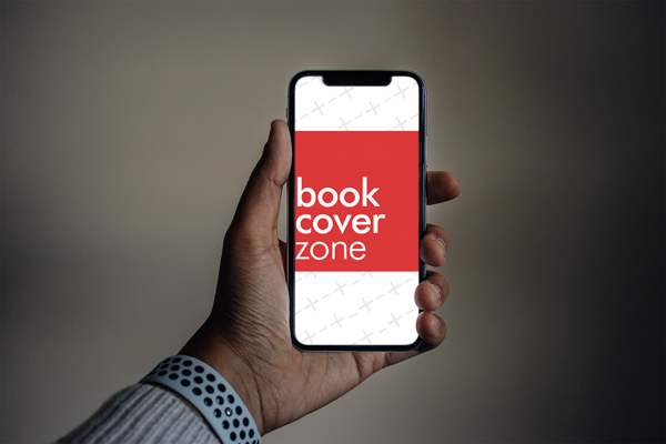 Man Holding iPhone XS on Dark Background