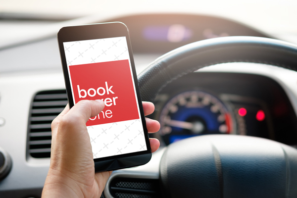 Man Holding Smartphone While Driving