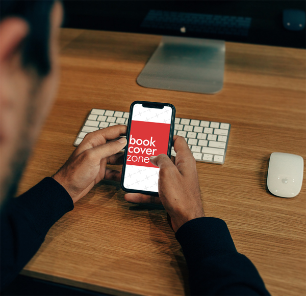 Man Using iPhone X on iMac