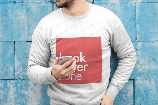 Man Using Smartphone Against Stone Wall