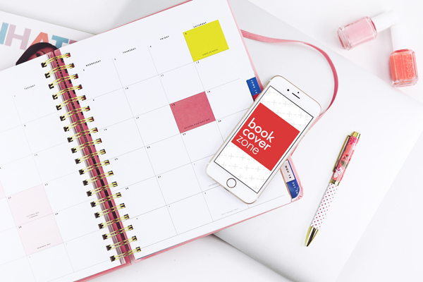 White iPhone Mockup on Busy Desk