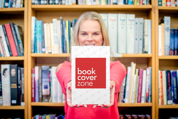 Young Woman Showcasing Book in Library
